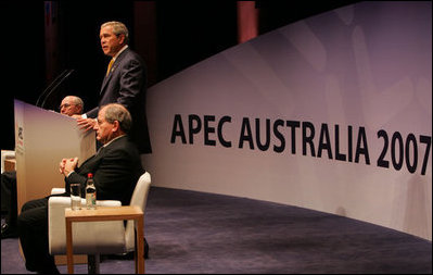 President George W. Bush speaks to the APEC Business Summit Friday, Sept. 7, 2007, at the Sydney Opera House. Joining him on stage are Australia's Prime Minister John Howard, far left, and Mark Johnson, Chairman of the APEC Business Advisory Council.