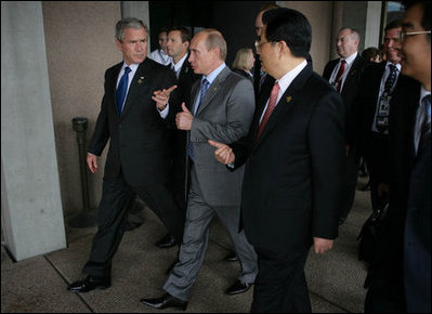 President George W. Bush, President Vladimir Putin of Russia, and President Hu Jintao of the People’s Republic of China, gesture as they walk to the APEC Leaders Retreat Saturday, Sept. 8, 2007, at the Sydney Opera House.