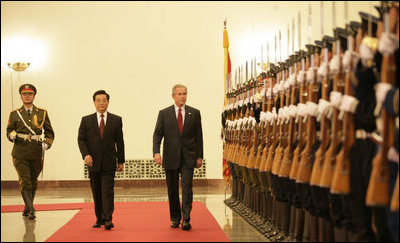 President George W. Bush and President Hu Jintao of the People's Republic of China, view Chinese troops during the welcome ceremonies for the President and Mrs. Bush at the Great Hall of People in Beijing.