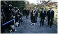 President George W. Bush and Japan’s Prime Minister Junichiro Koizumi join the Reverend Raitei Arima, Chief Priest of the Golden Pavilion Kinkakuji Temple in Kyoto, as they walk past the press during a cultural visit to the temple Wednesday, Nov. 16, 2005.