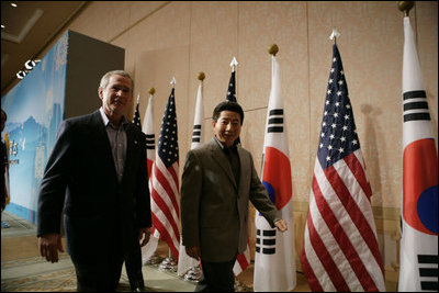 President George W. Bush and Moo Hyun Roh, President of the Republic of Korea, leave the stage at the Hotel Hyundai in Gyeongju, Korea Thursday, Nov. 17, 2005, after a joint press availability.