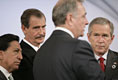 Canada's Prime Minister Paul Joseph Martin has the attention of President George W. Bush and fellow leaders of the Americas Friday, Nov. 18, 2005, as they meet at the Chosun Westin Hotel in Busan, Korea. Listening are, from left: Peru President Alejandro Toledo and Mexico President Vincente Fox.