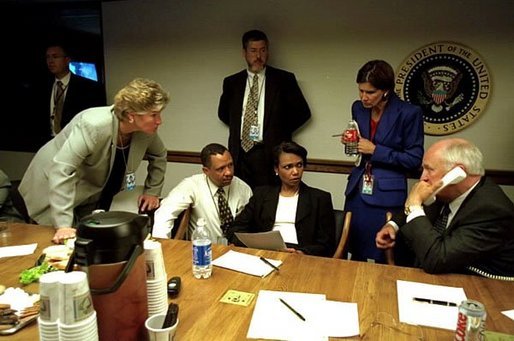 As Vice President Dick Cheney talks on the phone, Karen Hughes listens with fellow White House staff members in the Presidential Emergency Operations Center Sept. 11, 2001. White House photo by David Bohrer.