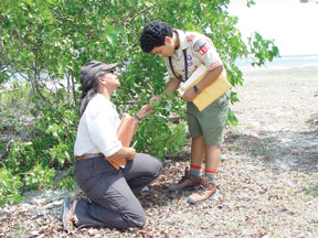 U.S. Fish and Wildlife Service biologist discusses wetland restoration with a Boy Scout in Puerto Rico. (FWS)