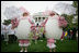 White House volunteers dressed in festive egg costumes stroll the South Lawn of the White House during the 2006 White House Easter Egg Roll, Monday, April 17, 2006.