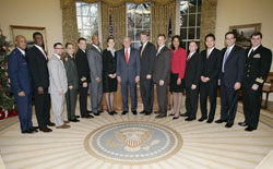 President George W. Bush poses with the 2006-2007 White House Fellows during an Oval Office meeting December 19, 2006; White House photo by Eric Draper