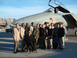 The 2002-03 White House Fellows class at Nellis Air Force Base, Nevada with an F-15 Eagle fighter jet.