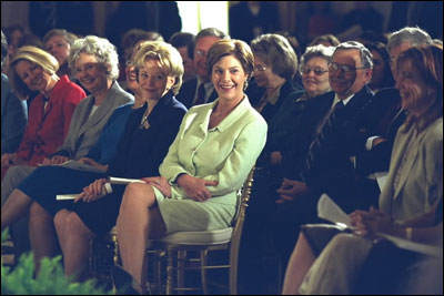 Laura Bush, Lynne Cheney and others laugh with Melissa Gilbert, right, child-star of the Little House on the Prairie Series based on Laura Ingalls Wilder books, during the White House Symposium on Women of the West, September 17, 2002. White House Photo by Susan Sterner.