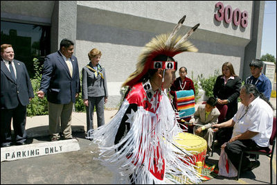 Laura Bush listens to a drumming performance by Native American children before touring the Native American Community Health Center Phoenix, Ariz., April 26, 2005. The center provides health care and other outreach services such as traditional ceremony training, dental care, women's wellness programming and case management services to Phoenix-area Native Americans.