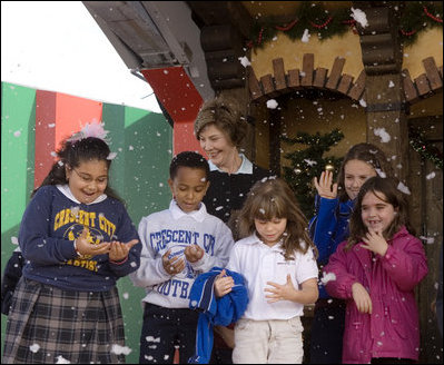 Laura Bush and children from New Orleans neighborhoods react to a downpour of fake snow flakes, Monday Dec. 12, 2005 at the Celebration Church in Metairie, La., during a Toys for Tots event.