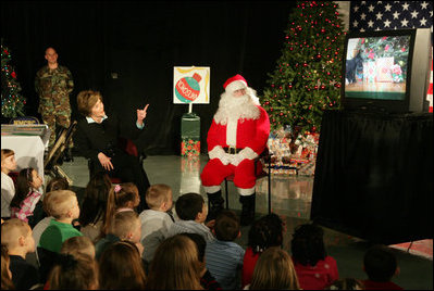 Laura Bush visits with children at the Naval and Marine Corps Reserve Center in Gulfport, Miss., Monday, Dec. 12, 2005, showing them a White House holiday video featuring the Bush's dogs "Barney and Miss Beazley."