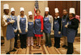 Mrs. Laura Bush and students at Cardozo Senior High School pose for pictures Monday, Dec. 19, 2005, in Washington, D.C. Mrs. Bush was on hand to join the Youth Services Opportunities Project in assembling sandwiches for Martha's Table's mobile soup kitchen.