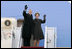 President George W. Bush and Laura Bush wave from the Air Force One stairs en route Brussels, Belgium, Sunday, Feb. 20, 2005. President Bush and Laura Bush flew from Andrews Air Force Base in Maryland to Belgium, beginning a five-day trip to Belgium, Germany and Slovakia.