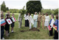 Mrs. Laura Bush looks on as Cherie Blair, wife of Prime Minister Tony Blair, takes the first dig during a tree-planting ceremony Thursday, July 7, 2005, at Glamis Castle, Scotland.