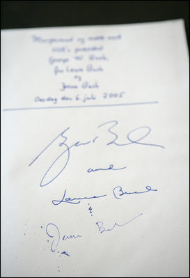 The signatures of President Bush and Laura Bush are written in the guest book at Prime Minister Anders Fogh Rasmussen's summer residence in Marienborg in Kongens Lyngby, Denmark, Wednesday, July 6, 2005.