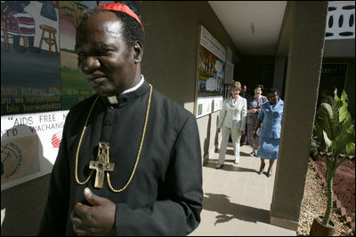 Led by Polycarp Cardinal Pengo, Laura Bush tours PASADA with Madame Anna Mkapa in Dar es Salaam, Tanzania, Wednesday, July 13, 2005. "For 13 years, the people of PASADA have provided services to men, women and children, whether they are infected with HIV or not. PASADA provides health education in communities, teaching teens and adults about the risks of HIV transmission," said Mrs. Bush in her remarks.