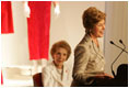 With former First Lady Nancy Reagan looking on, Laura Bush addresses the opening of The Heart Truth’s First Ladies Red Dress Collection Thursday, May 12, 2005, at the John F. Kennedy Center for the Performing Arts in Washington D.C. Mrs. Bush, the ambassador for The Heart Truth, wore her red Carolina Herrera suit to the Bolshoi Theater in Moscow and to The Heart Truth’s Red Dress Collection Fashion Show 2005 in New York City.