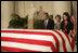 President George W. Bush and Laura Bush pay their respects to Chief Justice William Rehnquist as his body lies in repose in the Great Hall of the U.S. Supreme Court Tuesday, Sept. 6, 2005. Standing as honor guard for the Chief Justice is one of his former law clerks, Courtney Ellwood.