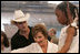 Laura Bush meets with people while visiting a clothing distribution site at the Biloxi Community Center, Tuesday, Sept. 27, 2005 in Biloxi, Miss., where she also interviewed with the television program, ABC's Extreme Makeover: Home Edition.