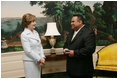 Mrs. Laura Bush enjoys a moment with Sal Tinajero Thursday, April 6, 2006, recipient of Hispanic Magazine's Teacher of the Year award in the Diplomatic Room at the White House. Along with being a World History teacher, Mr. Tinajero resurrected the Speech and Debate team at Fullerton Union High School in Santa Ana, California.