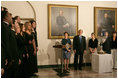 President George W. Bush and Laura Bush listen to Indiana University's A Cappella Choir, HooShir, sing during the lighting of the Menorah during the annual White House Hanukkah reception Monday, Dec. 18, 2006. Pictured at right is Ariel Cohen, 14, and her parents Dan and Rachel Cohen.