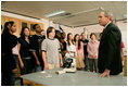 President George W. Bush speaks with science and engineering students after touring the Yvonne A. Ewell Townview Magnet Center in Dallas, Texas, Friday, Feb. 3, 2006.