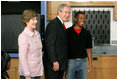 President George W. Bush and Mrs. Laura Bush greet student Michael Harrell during a visit with science and engineering students at the Yvonne A. Ewell Townview Magnet Center in Dallas, Texas, Friday, Feb. 3, 2006.