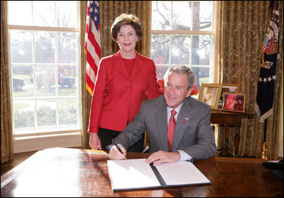 President George W. Bush is joined by Laura Bush, Wed. Feb. 1, 2006 in the Oval Office at the White House, as he signs a proclamation in honor of American Heart Month.