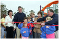 Laura Bush attends a ribbon cutting ceremony with football star Brett Favre and his wife, Deanna, left, Secretary Margaret Spelling, center, Dan Vogel, Associate Director, USA Fredom Corps, right, and student of Hancock North Central Elementary Shool at the Kaboom Playground, built at the Hancock North Central Elementary School in Kiln, Ms., Wednesday, Jan. 26, 2006, during a visit to the area ravaged by Hurricane Katrina.