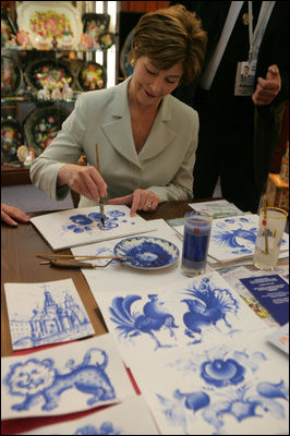 Mrs. Laura Bush participates in an arts and crafts demonstration Monday, July 17, 2006, during an exhibit at the Baltic Star Hotel on the grounds of the Konstantinovsky Palace Complex in Strelna, Russia, site of the G8 Summit that ended Monday.