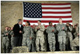 President George W. Bush meets and thanks a group of U.S. and Coalition troops, Wednesday, March 1, 2006, during a visit to Bagram Air Base in Afghanistan, where President Bush thanked the troops for their service in defense of freedom.