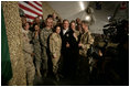 President George W. Bush poses for photos with U.S. and Coalition troops Wednesday, March 1, 2006, during a stopover at Bagram Air Base in Afghanistan, prior to his visit to India and Pakistan.