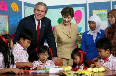 President George W. Bush and Mrs. Laura Bush pose with 6th graders during a drop-by education event Monday, Nov. 20, 2006, at the Bogor Palace in Bogor, Indonesia.