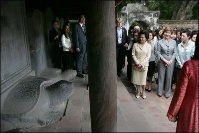 Mrs. Laura Bush is joined by other spouses of APEC leaders Saturday, Nov. 18, 2006, as they tour the Temple of Literature in Hanoi, site of the 2006 APEC summit.
