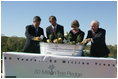 Mrs. Laura Bush is joined by, from left, U.S. Department of Agriculture Secretary Mike Johanns; John Rosenow, president of the National Arbor Day Foundation, and Andy Taylor, chairman and CEO of Enterprise Rent-A-Car, as they plant White Pine saplings Thursday, October 11, 2006, during a ceremony for the Enterprise 50 Million Tree Pledge in St. Louis, Missouri. Enterprise Rent-A-Car donated $50 million to the National Arbor Day Foundation to plant 50 million trees in National Forests over the next 50 years. The White Pine saplings planted at the ceremony will be re-planted permanently in the Mark Twain National Forest in southern Missouri.