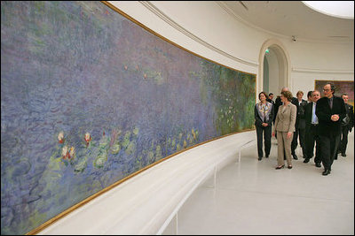 Mrs. Laura Bush tours the Musee de l'Orangerie with Director Pierre Georgel, right, and US Ambassador Craig Stapleton and his wife Mrs. Stapleton, left, in Paris Monday, Jan. 15, 2007. The Musee de l'Orangerie is home to eight paintings from Monet's large-format series of Water Lilies.