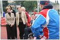 Mrs. Laura Bush visits with members of the Russian Paralympic Team Sunday, April 6, 2008, during a visit to Central Sochi Stadium in Sochi, Russia. Standing with her is her interpreter, Marina Gross.