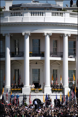 President George W. Bush and Mrs. Laura Bush stand with Pope Benedict XVI as he acknowledges the cheers from the crowd from the South Portico balcony Wednesday, April 16, 2008, on the South Lawn of the White House. 