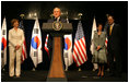 President George W. Bush and Mrs. Laura Bush receive a warm welcome during their arrival in Seoul on August 6, 2008. With the Bush's onstage at the United States Embassy is Ambassador Sandy Vershow, right, and Lisa Vershbow.