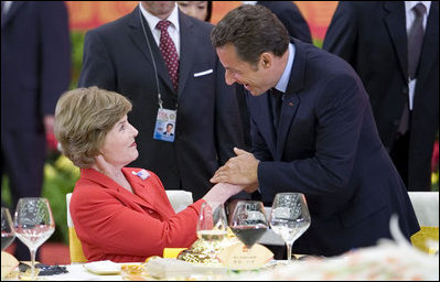 Mrs. Laura Bush is greeted by France President Nicolas Sarkozy during a social luncheon Friday, Aug. 8, 2008, at the Great Hall of the People in Beijing in honor of the 2008 Summer Olympic Games.