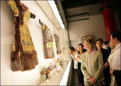 Mrs. Laura Bush closely examines a display at the Exhibition of Imperial Garments and Jewelry Saturday, Aug. 9, 2008, during her tour of the Forbidden City in Beijing.