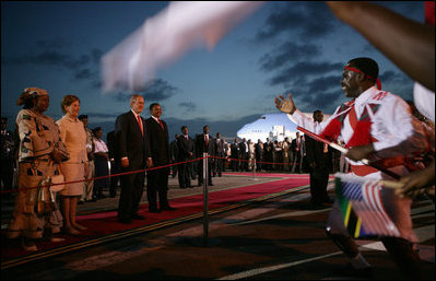President George W. Bush and Mrs. Laura Bush are joined by President Jakaya Kikwete of Tanzania and his wife, Sala Kikwete as they watch performers during the arrival ceremony Saturday, Feb. 16, 2008, at Julius Nyerere International Airport in Dar es Salaam.