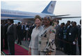 Mrs. Laura Bush and Salma Kikwete, wife of President Jakaya Kikwete of Tanzania, stand on the red carpet Saturday, Feb. 16, 2008, after the arrival of President George W. Bush and Mrs. Bush to Julius Nyerere International Airport in Dar es Salaam.
