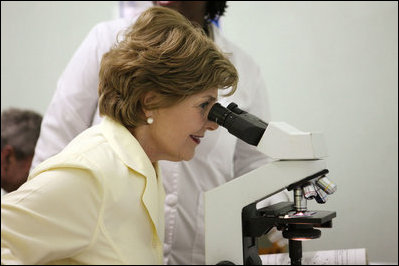Mrs. Laura Bush views a medical slide thru a microscope Monday, Feb. 18, 2008, during a tour of the Meru District Hospital outpatient clinic in Arusha, Tanzania.