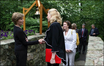 Mrs. Laura Bush greets the directors of Presidential Libraries Wednesday, June 4, 2008, at the entrance to Camp David's Evergreen Chapel in Thurmont, Maryland. Mrs. Bush shakes hands with Ms. Nancy Smith, Director of the National Archives' Presidential Material Staff in Alexandria, VA.