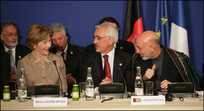 Mrs. Laura Bush, seated next to Afghanistan Foreign Minister Dr. Rangin Dadfar Spanta, speaks with Afghanistan President Hamid Karzai, right, during the U.S.-Afghan Donor's Conference Thursday, June 12, 2008, in Paris.