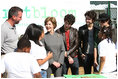 Surrounded by children participating in a soil sampling event, Mrs. Laura Bush speaks with Benjamin Jones, Director of Education, Trinity River Audubon Center, left during the First Bloom event at the Trinity River Audubon Center Sunday, November 2, 2008, in Dallas, TX. Mrs. Bush is joined by singer/songwriters the Jonas Brothers, Kevin Jonas, Joe Jonas, and Nick Jonas, right.