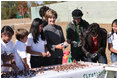 Surrounded by children Mrs. Laura Bush practices making seed balls during a First Bloom event at the Trinity River Audubon Center, Sunday, November 2, 2008, in Dallas, TX. Mrs. Bush is joined by singer/songwriters the Jonas Brothers, Kevin Jonas, Joe Jonas, and Nick Jonas, right.