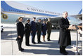 President George W. Bush, joined by Mrs. Laura Bush, stands outside Air Force One as he addresses his remarks in honor of Veterans Day, Tuesday, Nov. 11, 2008 upon the President's arrival at John F. Kennedy International Airport in New York. President Bush introduced military personnel representing the five branches of the armed services, who traveled with him aboard AF-1, honoring their service, from left are, U.S. Navy Chief Petty Officer Shenequa Cox of Dallas, Texas; U.S. Coast Guard Petty Officer First Class Christopher O. Hutto of Homer, Alaska; U.S. Army National Guard SSgt Michael Noyce-Merino of Melrose, Montana; U.S. Air Force Senior Airman Alicia Goetschel of Warrensburg, Mo., and U.S. Marine Corps Sgt. John Badon of Lufkin, Texas.