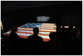 President George W. Bush is silhouetted against the renovated Star-Spangled Banner American flag exhibit Wednesday, Nov. 19, 2008, during his visit with Mrs. Laura Bush to the National Museum of American History in Washington, D.C. The flag, which flew above Fort McHenry in Baltimore during the British attack in 1814, inspired Francis Scott Key to write the lyrics that became our national anthem.